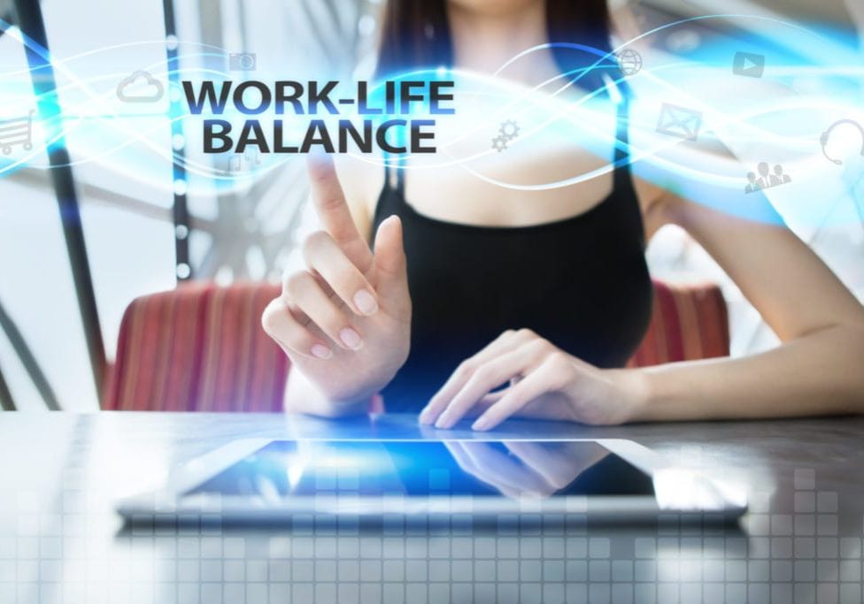 Woman is using tablet pc, pressing on virtual screen and selecting work-life balance