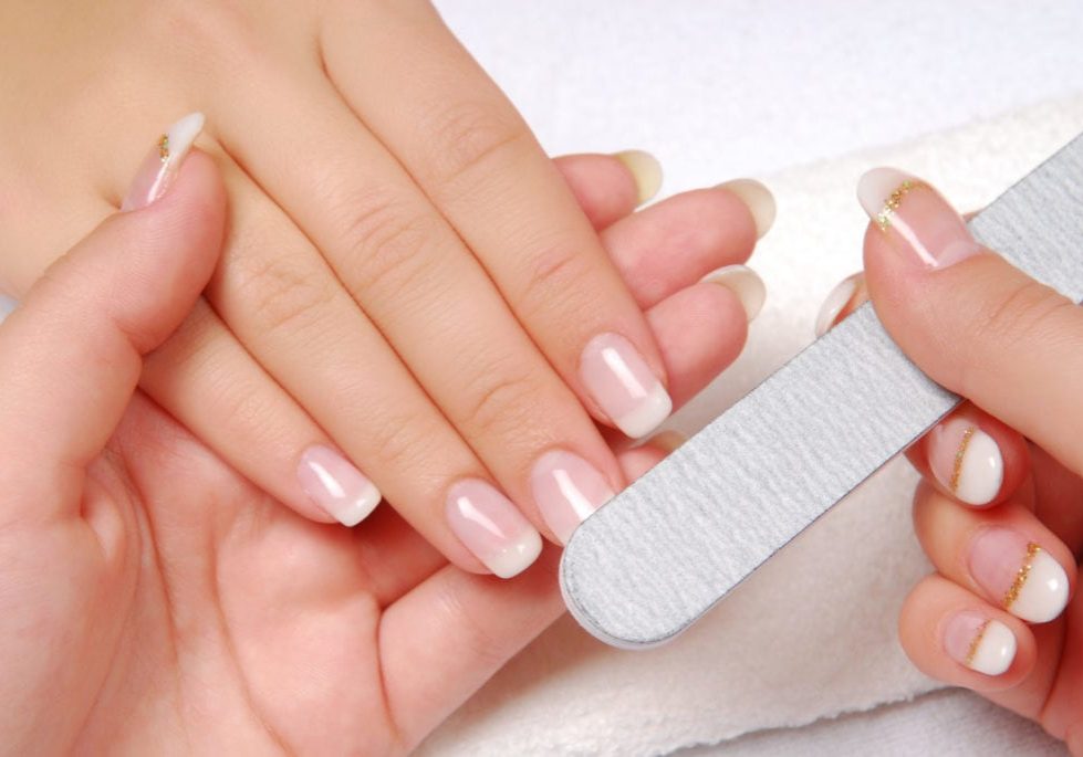Studio nail — beautician polishing female nails