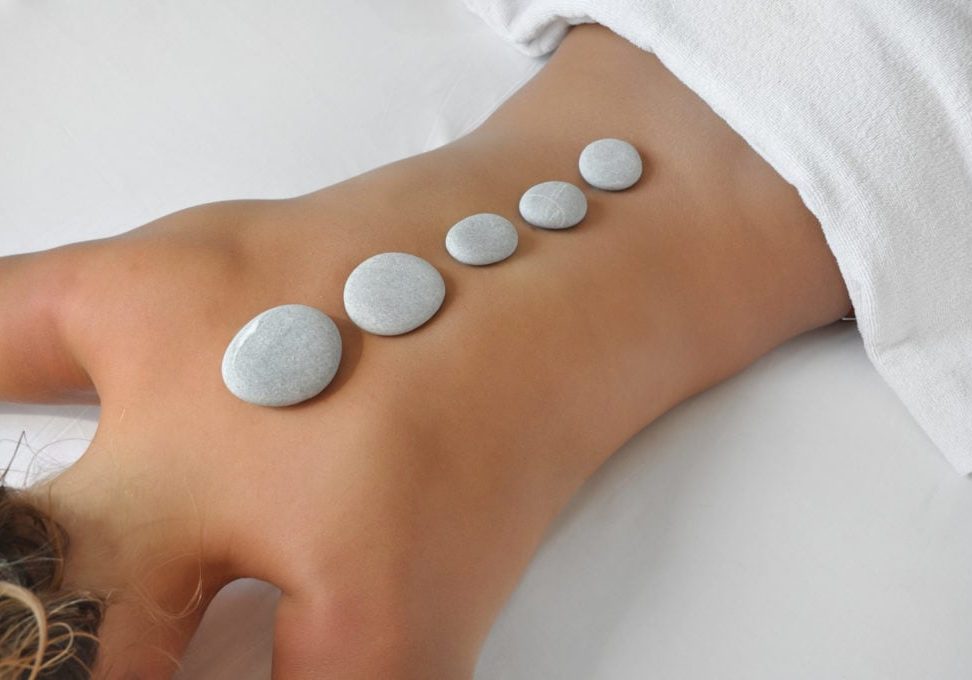young woman in a spa having hot stones treatment