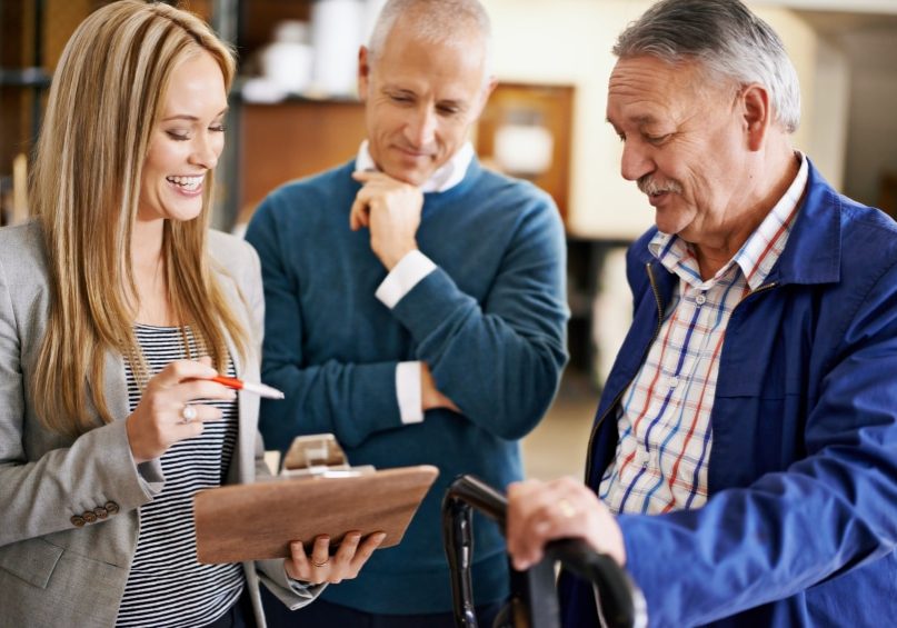 Shot of people talking together over a clipboard in a distribution warehouse